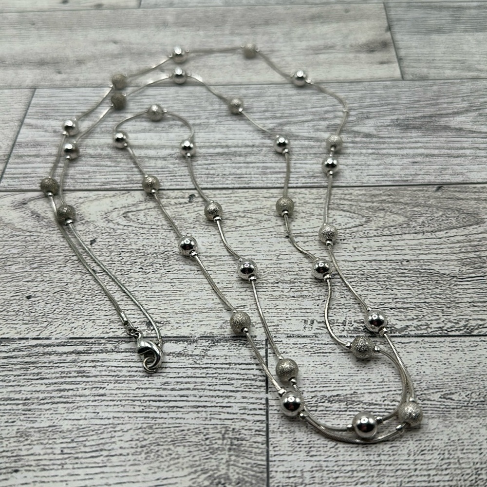 Silver tone beaded long necklace with lobster clasp